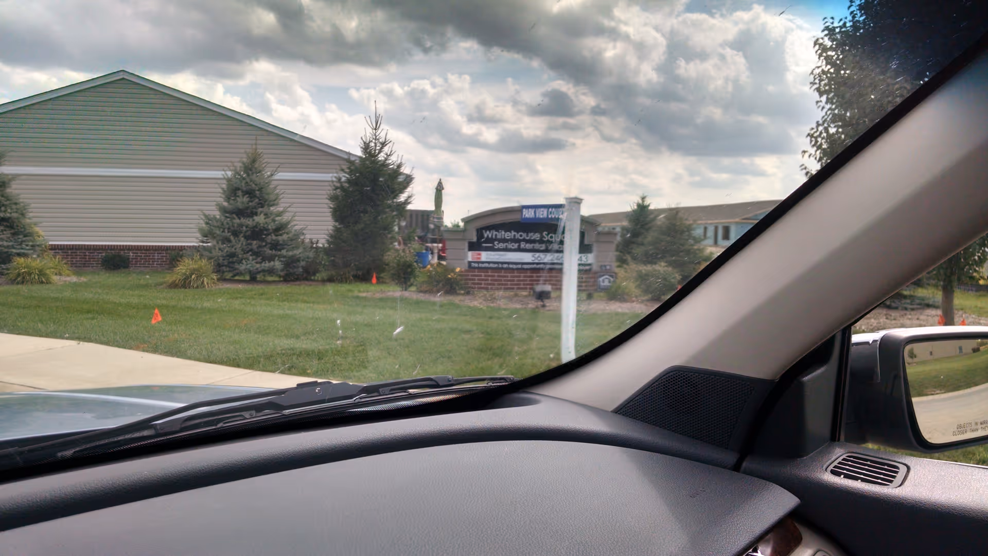 From inside a car, exterior view of Whitehouse Square Senior facility.