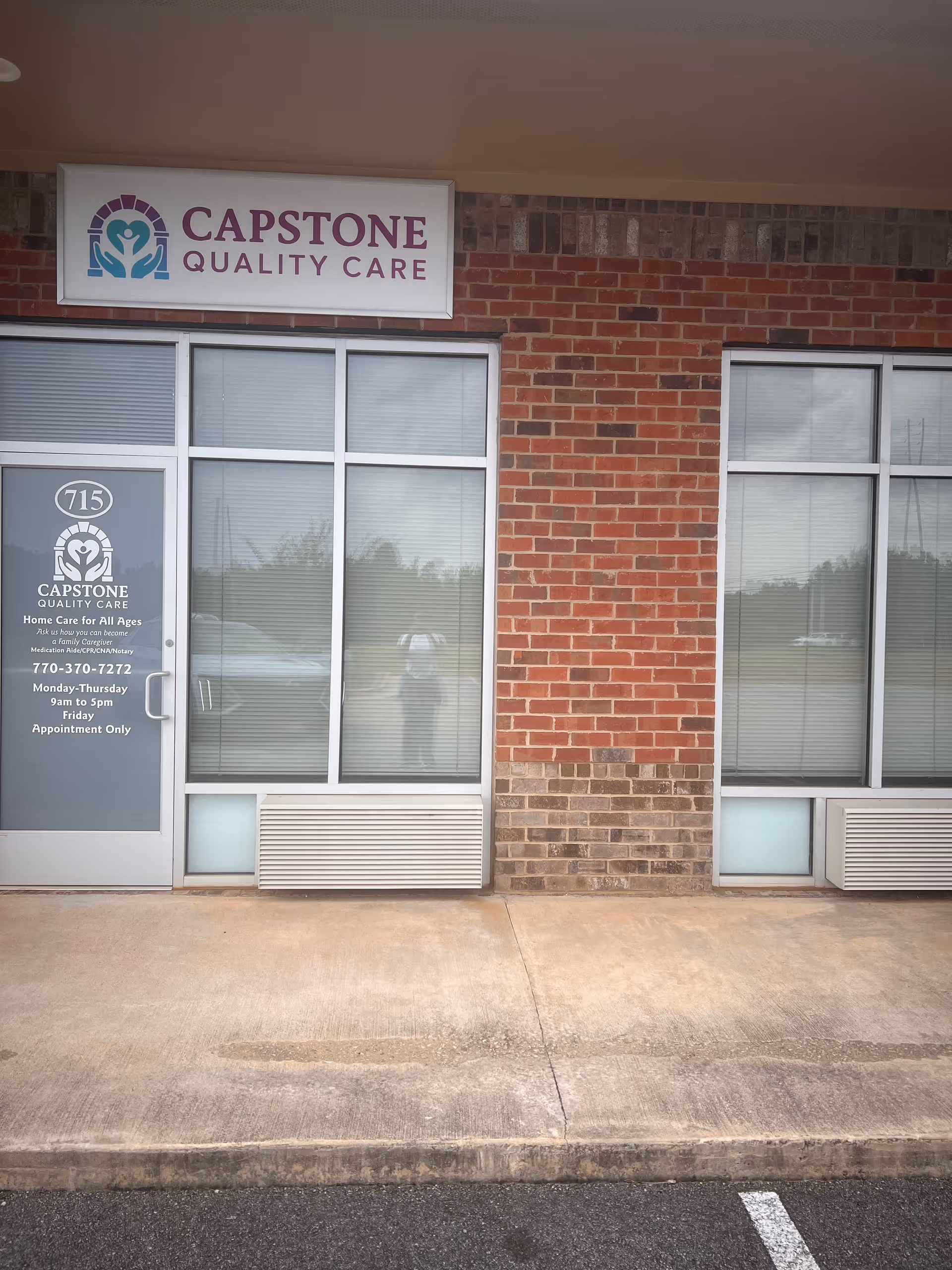 Brick storefront with Capstone Quality Care sign and glass entrance doors.