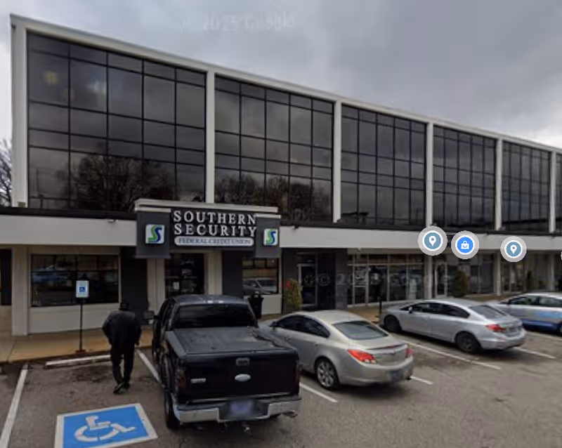 Glass-front building with a Southern Security Federal Credit Union sign and several parked cars.