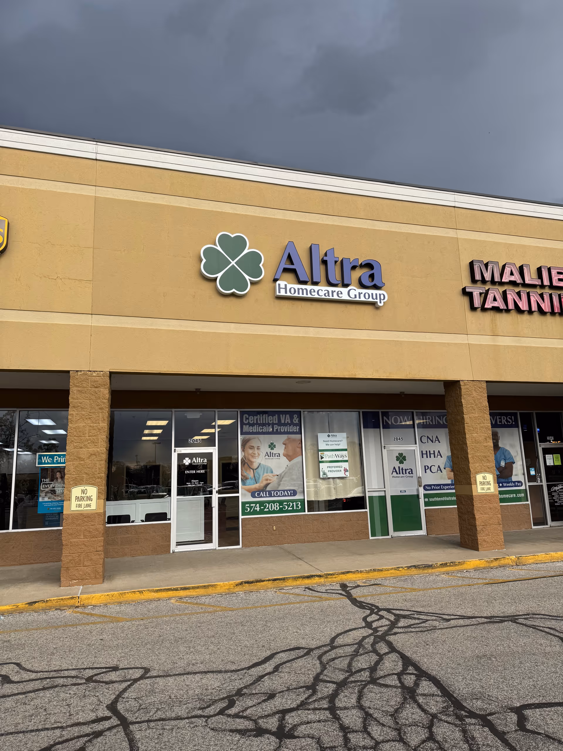 Exterior storefront of Altra Homecare Group with a large sign and pillars in a strip mall.