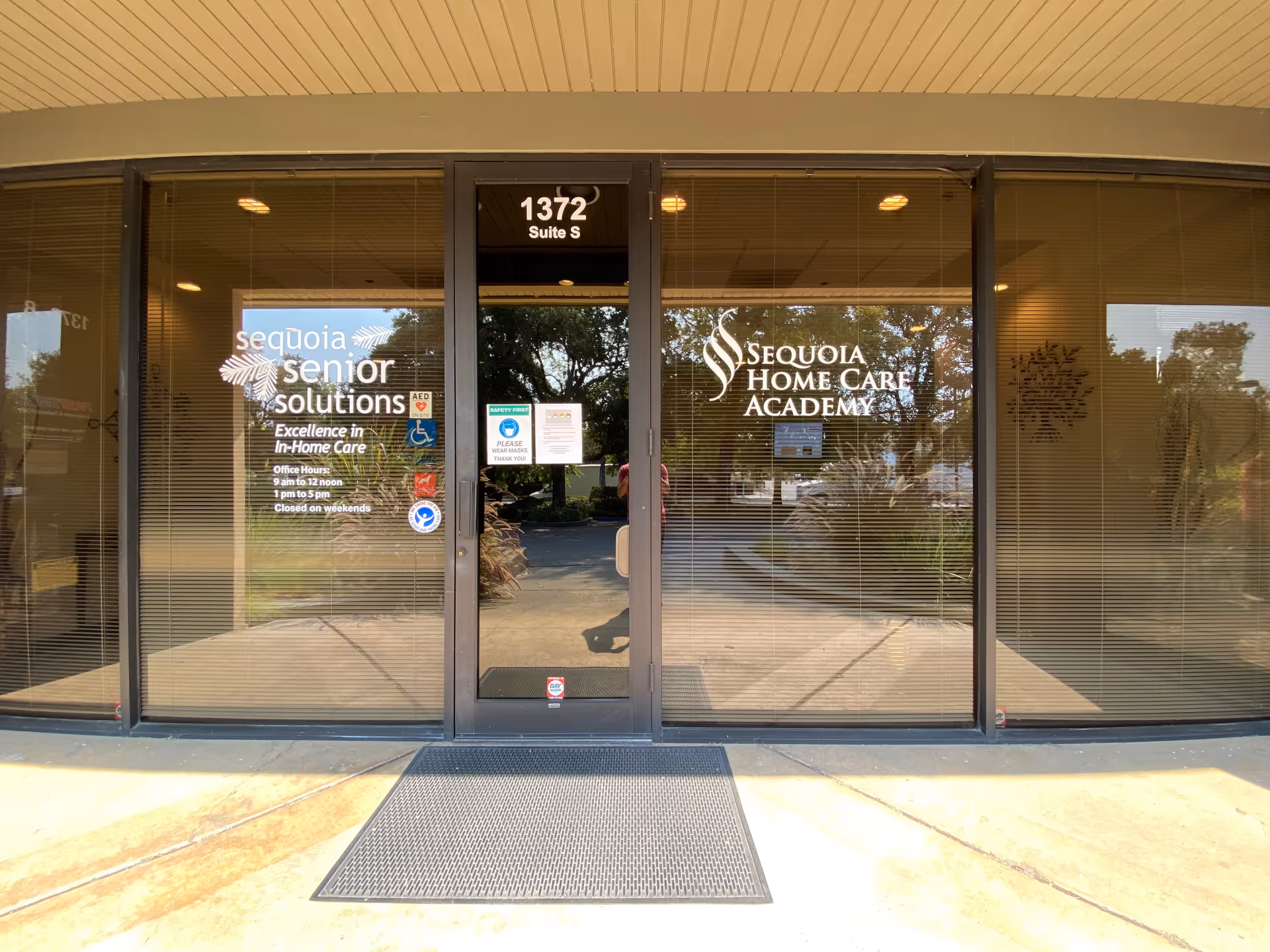 Glass storefront entrance with Sequoia Senior Solutions and Sequoia Home Care Academy signage.