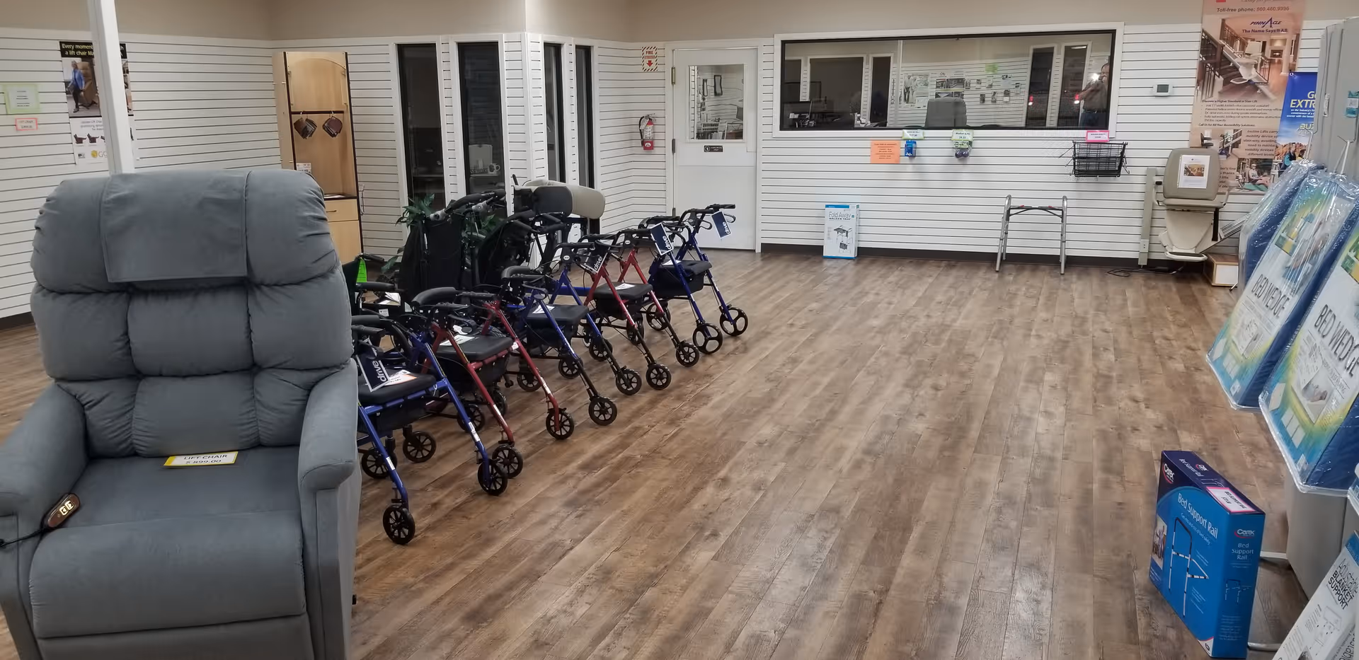 A showroom area inside a senior facility displays walkers, a large gray recliner, and medical supplies.