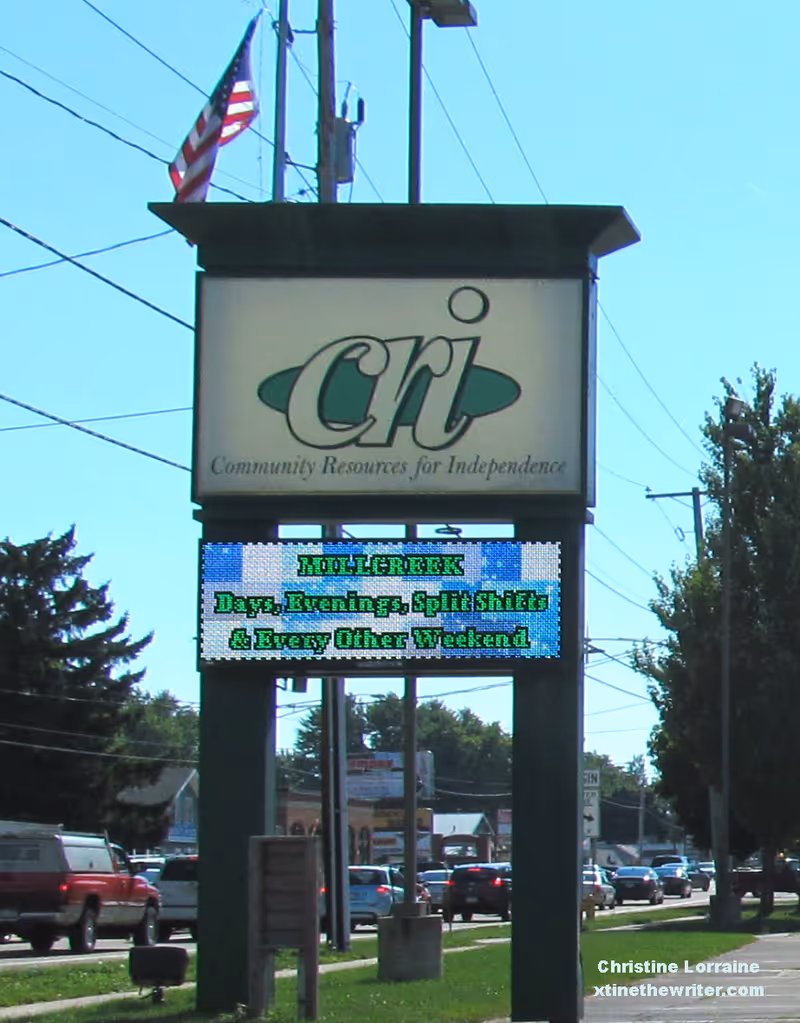 Outdoor sign for Community Resources for Independence in Erie, PA, with digital message board.