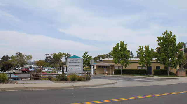 Exterior view of Sharp Grossmont Hospital Outpatient Services at Brier Patch with trees and parking