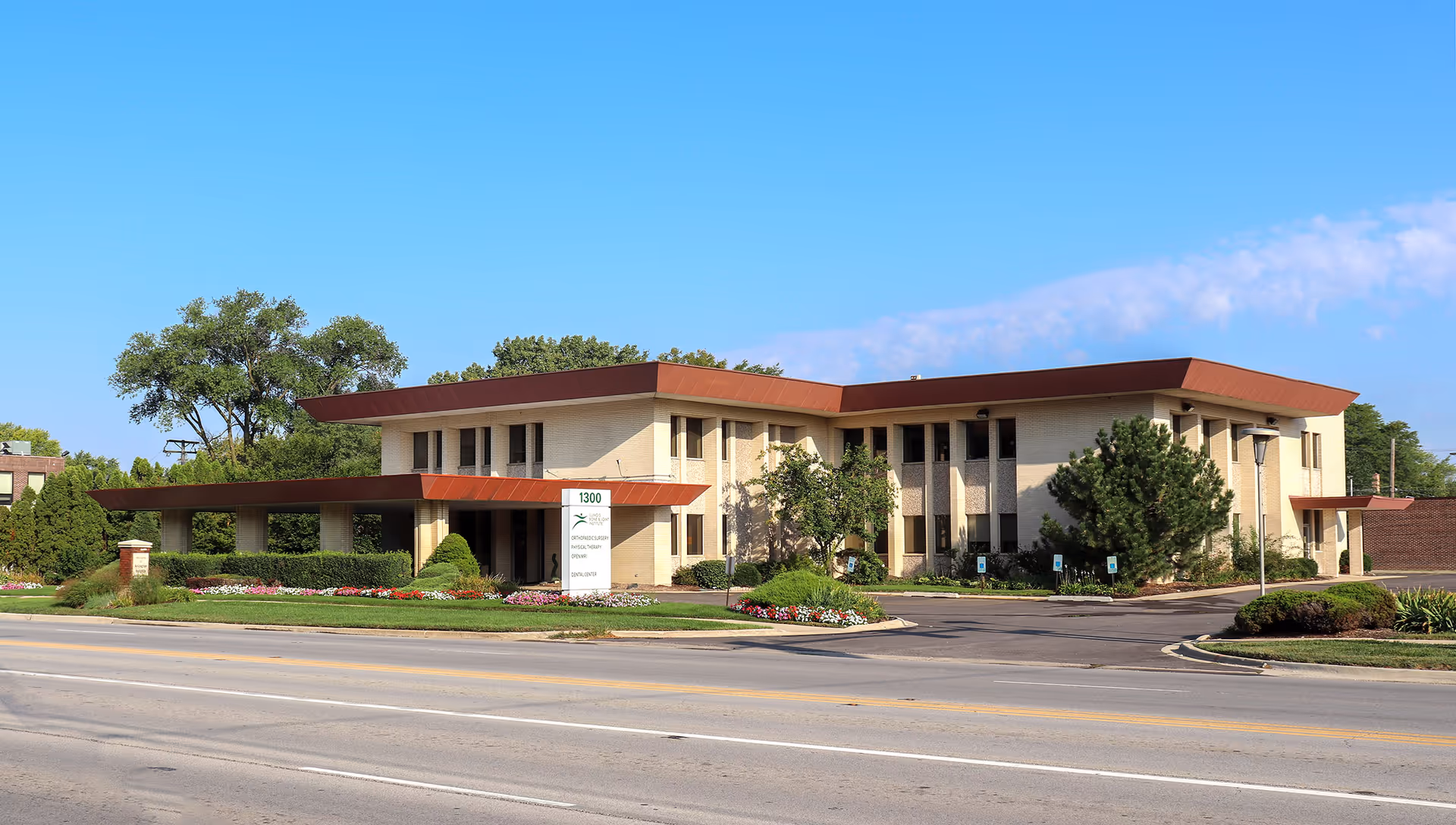 Exterior view of IBJI Physical & Occupational Therapy building with landscaped grounds and entrance sign.