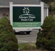 Front view of Always There Home Care sign with shrubs and parking lot.