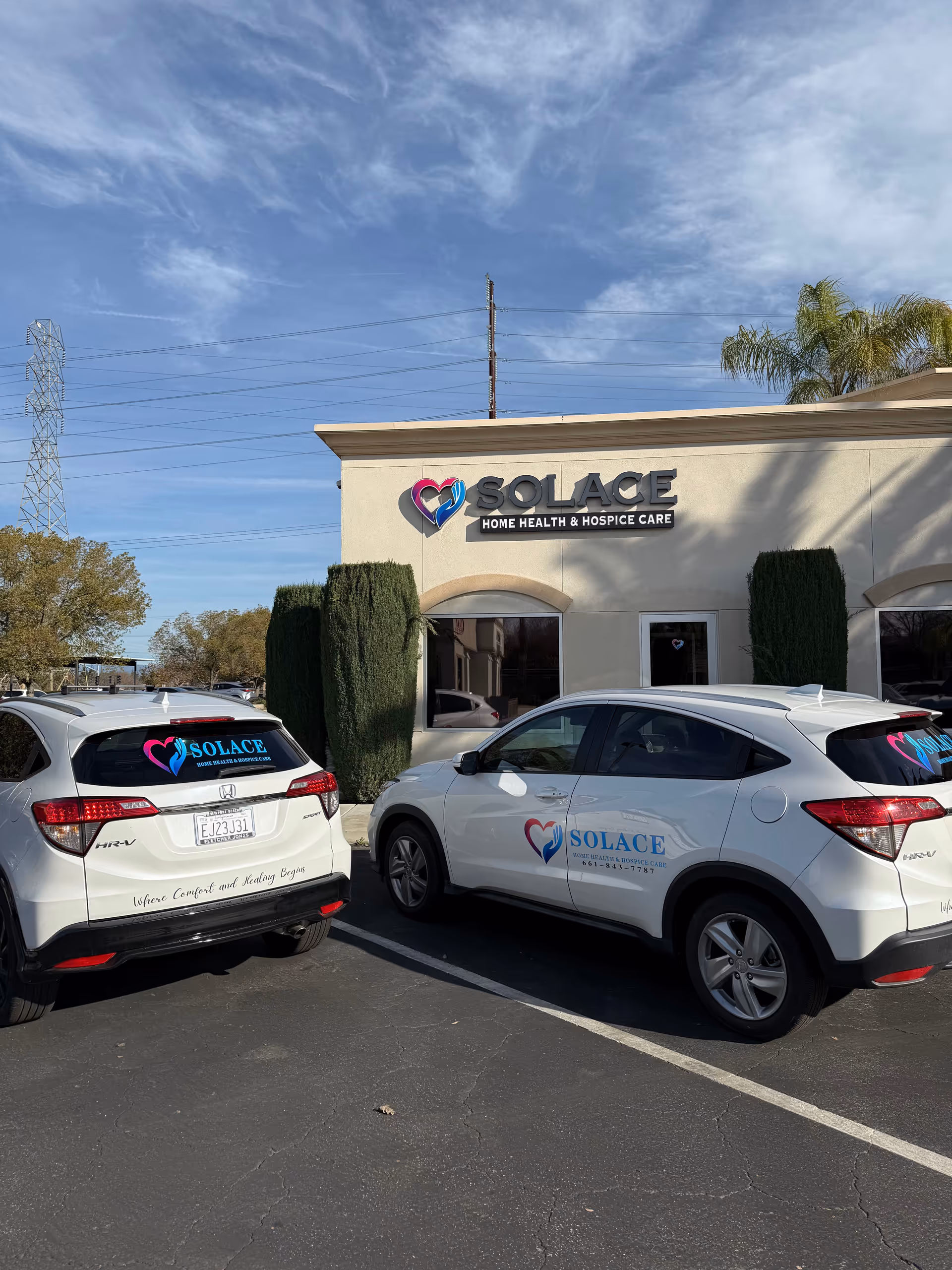 Exterior view of Solace facility with branded cars parked in front.