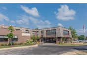 Front exterior of Westmont Manor Health and Rehab Center, brick building with entrance and parking.
