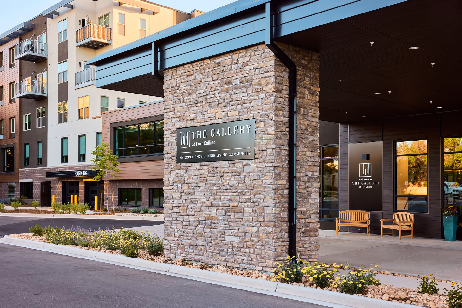 Exterior view of The Gallery at Fort Collins Leasing Center with stone pillar and sign