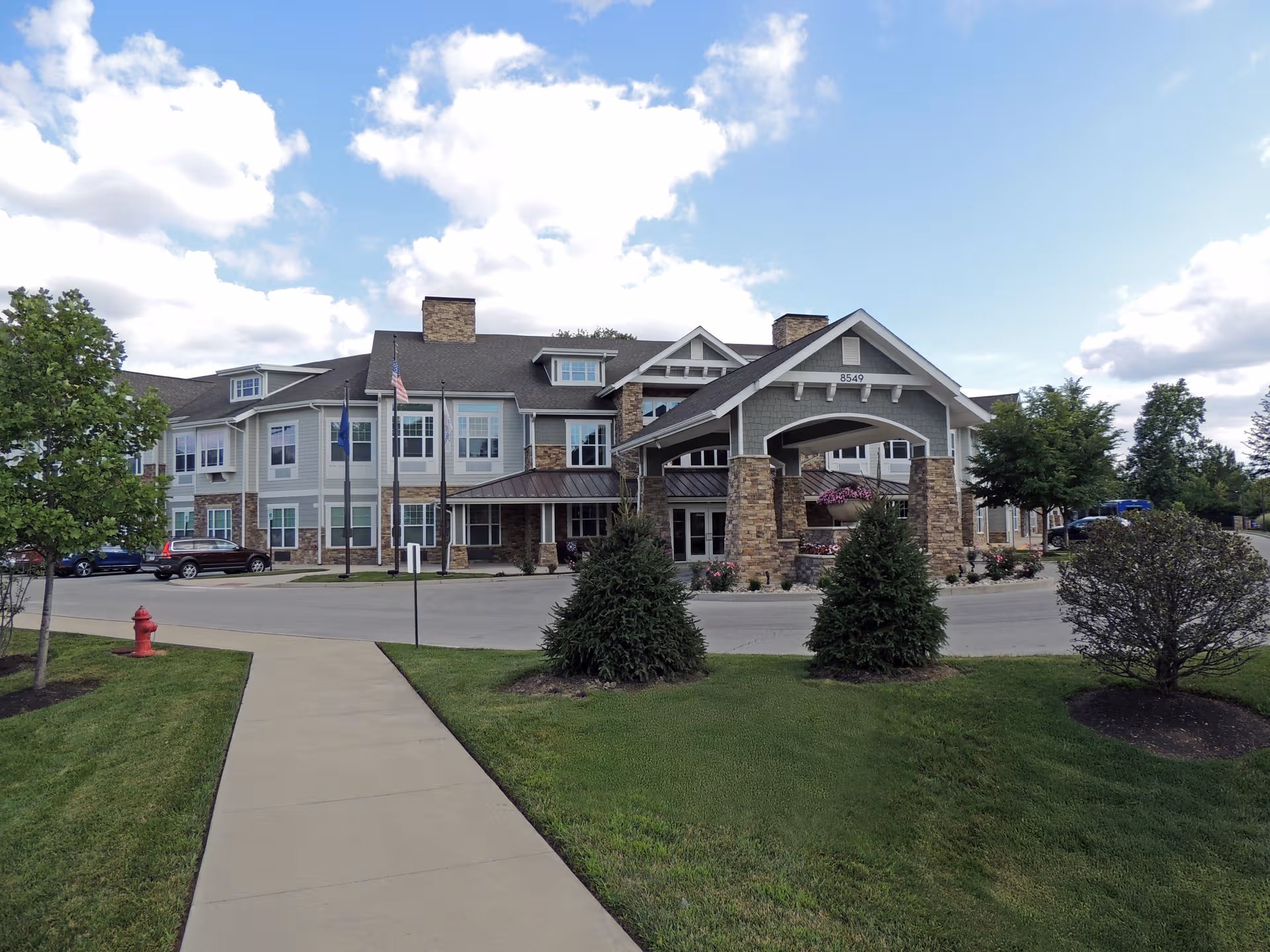 Exterior view of The Commons on Meridian with entrance arch and manicured lawn.