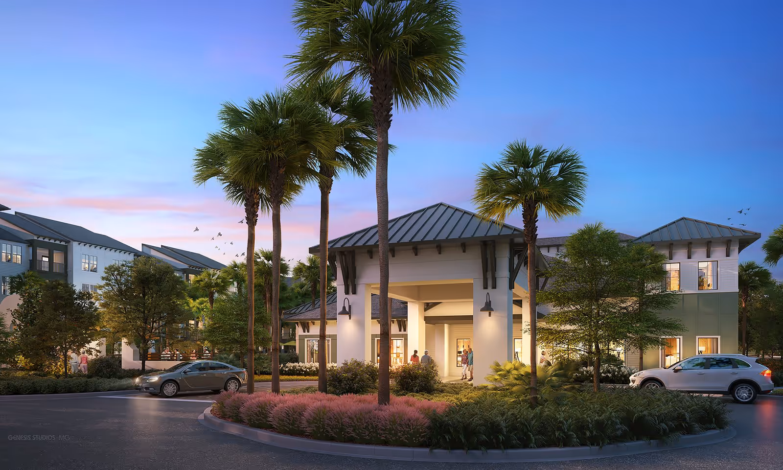 Entrance of a modern 55+ apartment community building landscaped with palm trees, a circular drive and parked cars at dusk.