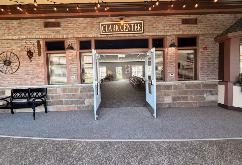 Brick-front entrance labeled Clark Center with open double doors leading inside.