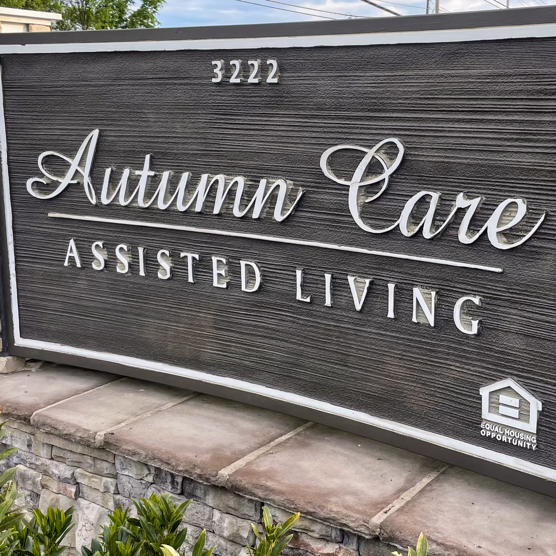 Exterior sign reads Autumn Care Assisted Living with 3222 and Equal Housing logo.
