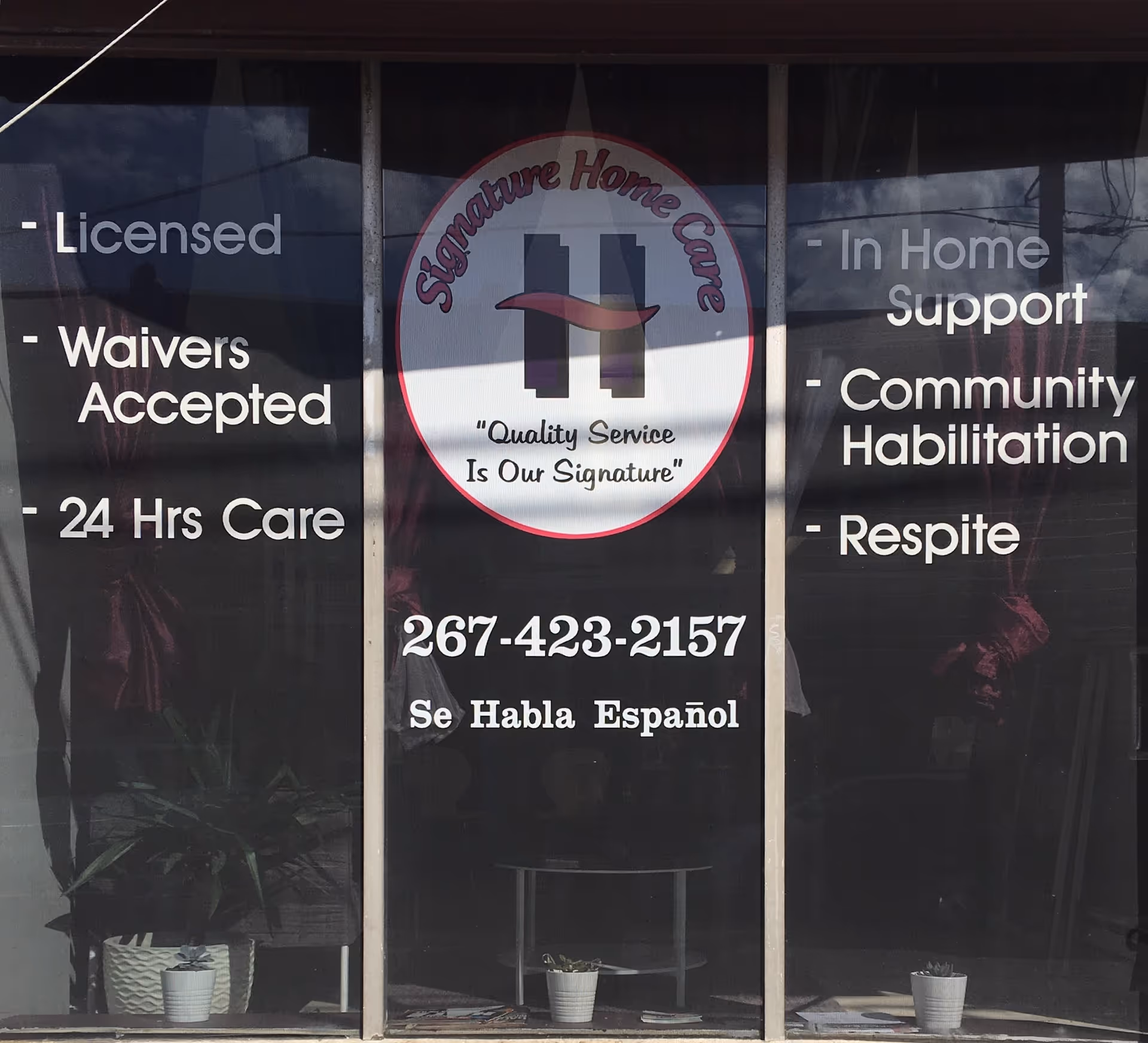 Storefront window displaying Signature Home Care logo and service listings on glass panels