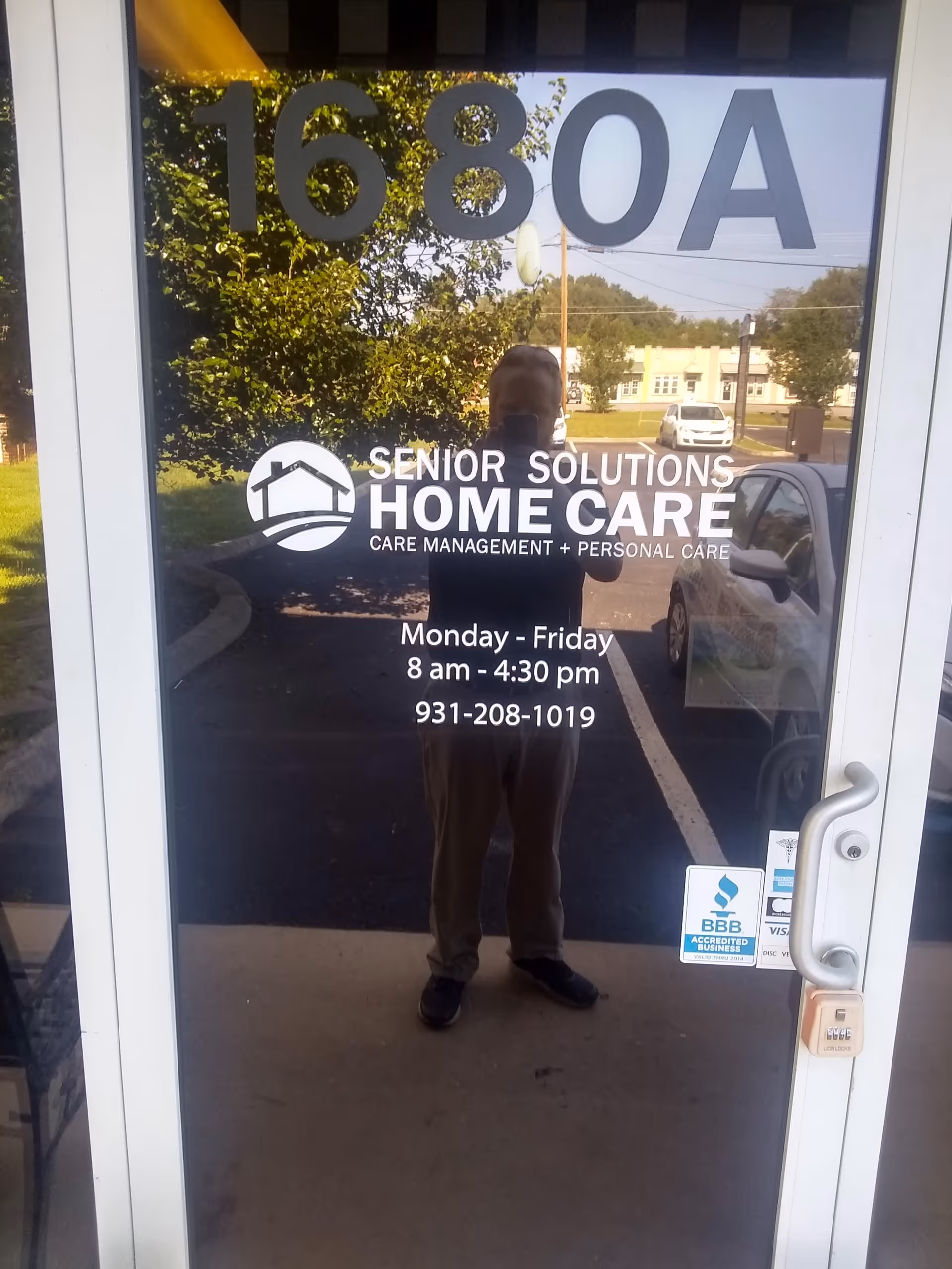 Glass entrance door displaying Senior Solutions Home Care logo and service hours