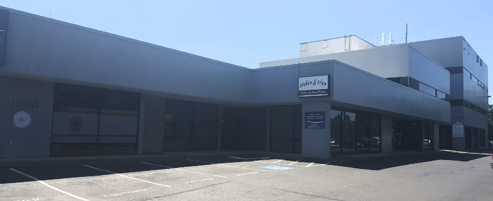 Exterior view of the Eugene Signature HCH Home Health building with parking and storefront windows.