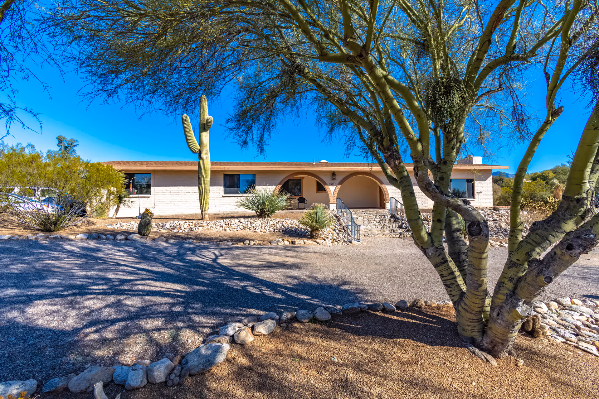 Front view of Canyon View Adult Care Home with desert landscaping and arches.