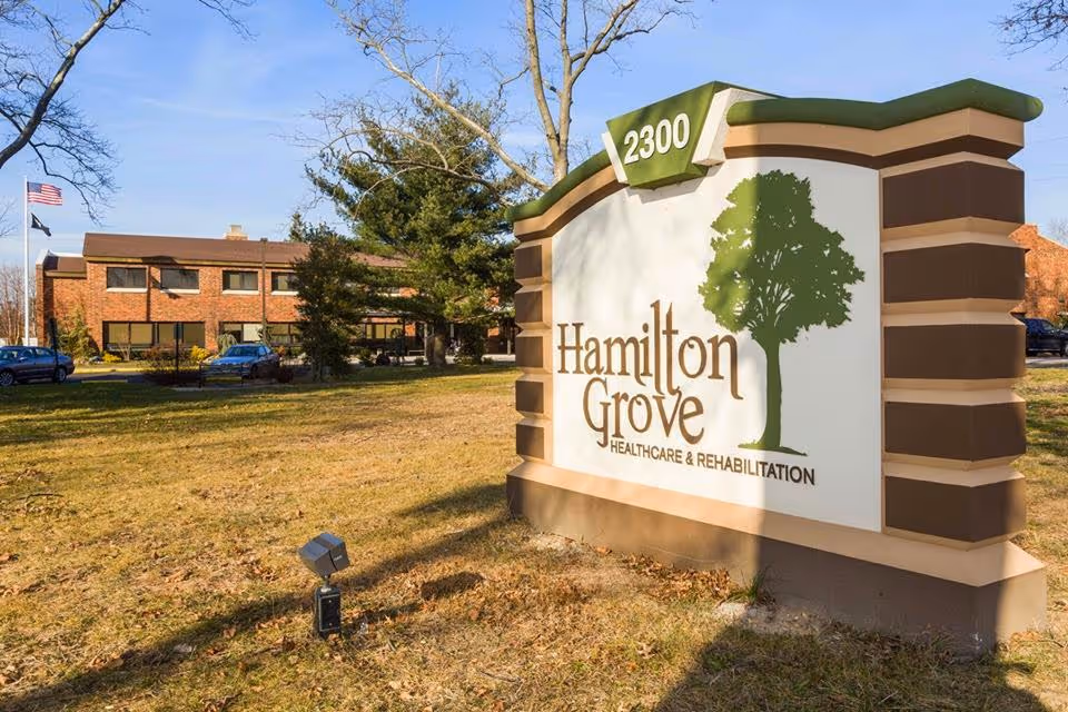 Exterior view of Hamilton Grove Healthcare and Rehabilitation sign with the building in the background.