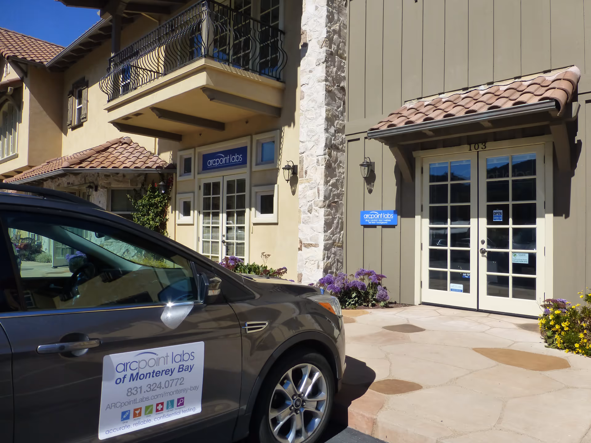 Exterior view of ARCpoint Labs building with a parked car in front.