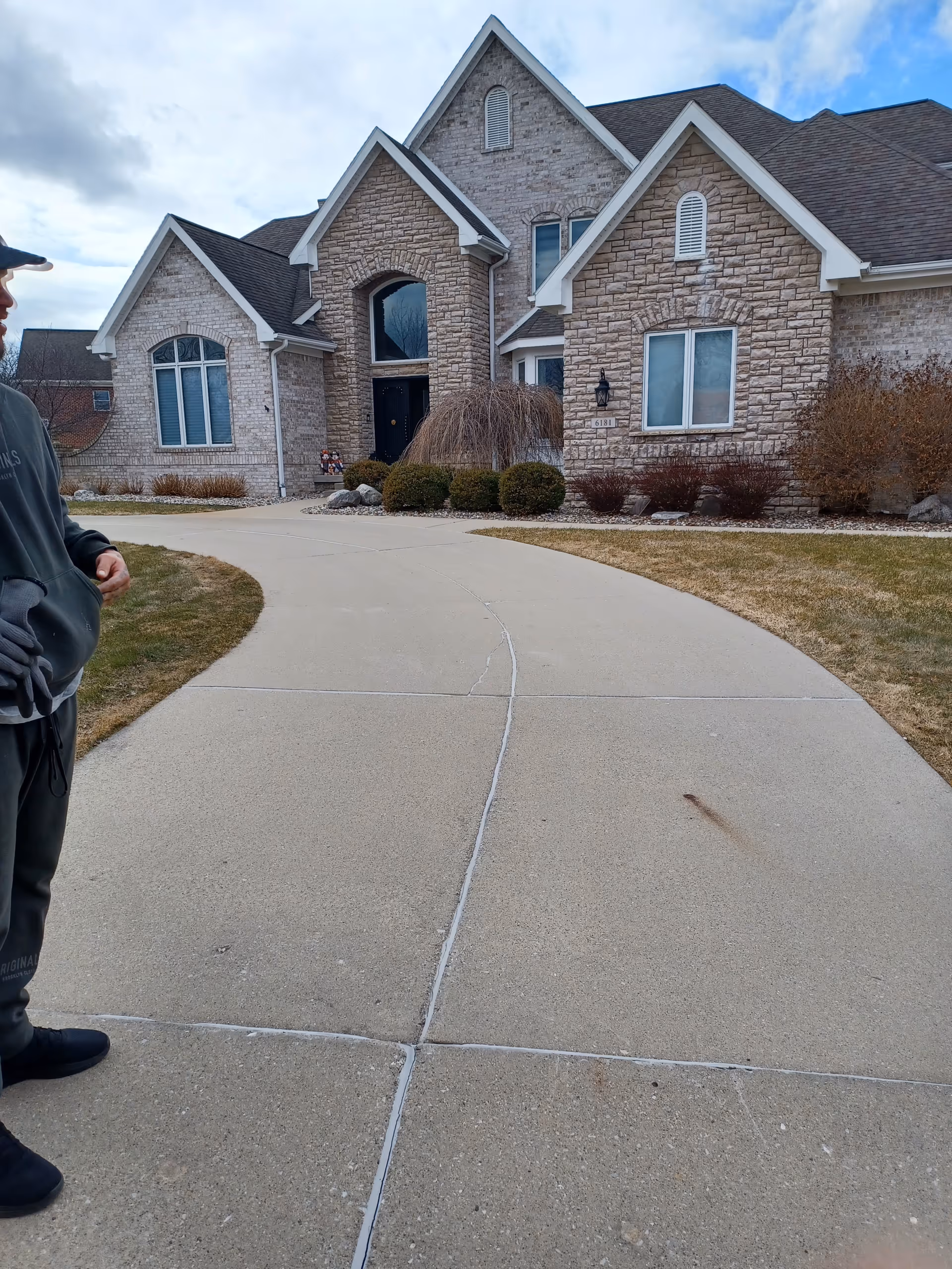 Front exterior of Medilodge of East Lansing with curved driveway and landscaped entry.