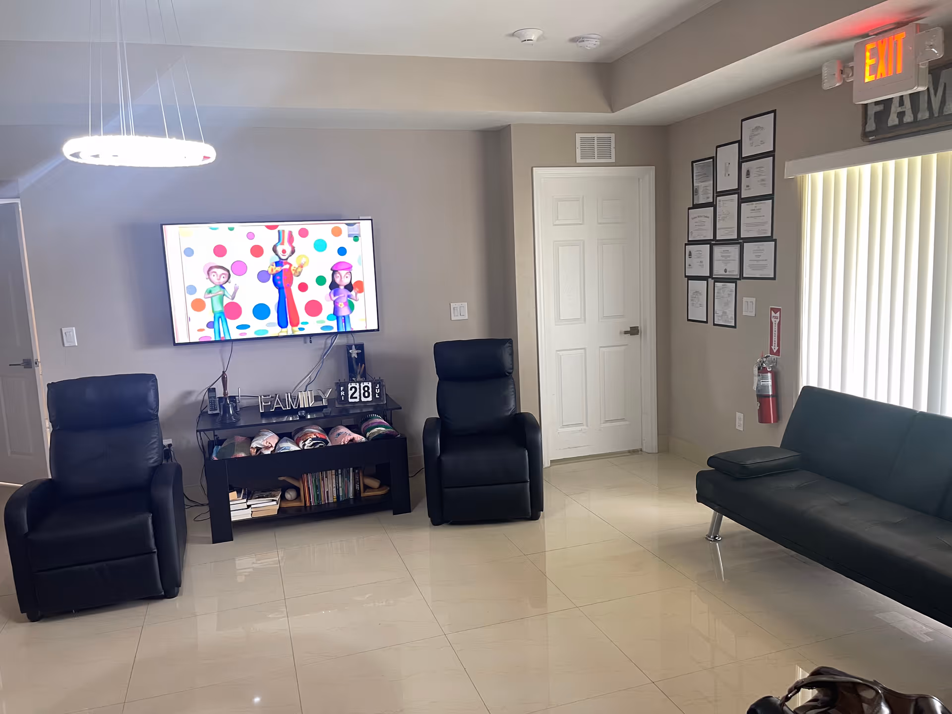 Cozy common living room with two recliners, a sofa, and a wall-mounted TV.