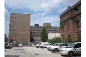 Exterior view of Philadelphia Nursing Home buildings with a parking lot in front.