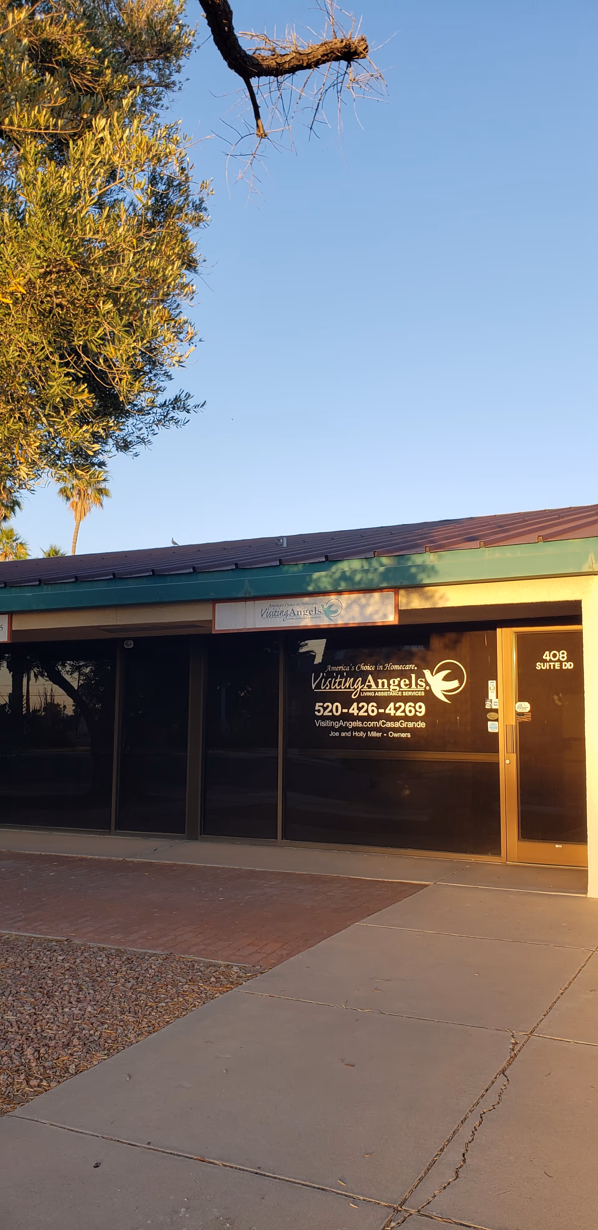 Exterior view of Visiting Angels Senior Home Care Casa Grande storefront with glass windows and signage.