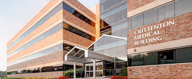Exterior view of a brick medical building with glass entrance and CRITTENTON MEDICAL BUILDING sign.