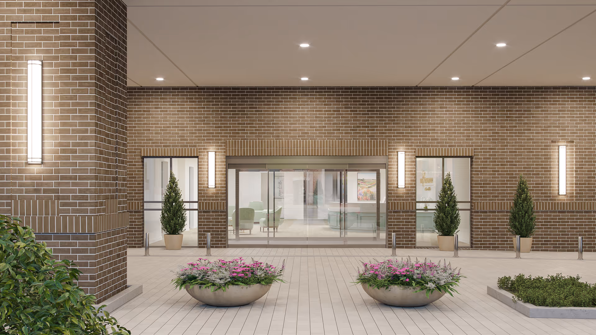Brick building entrance at a senior living facility with glass doors, brick walls, and potted plants.