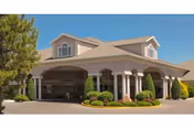 Front view of Life Care Center of Treasure Valley with arched entrance and landscaping