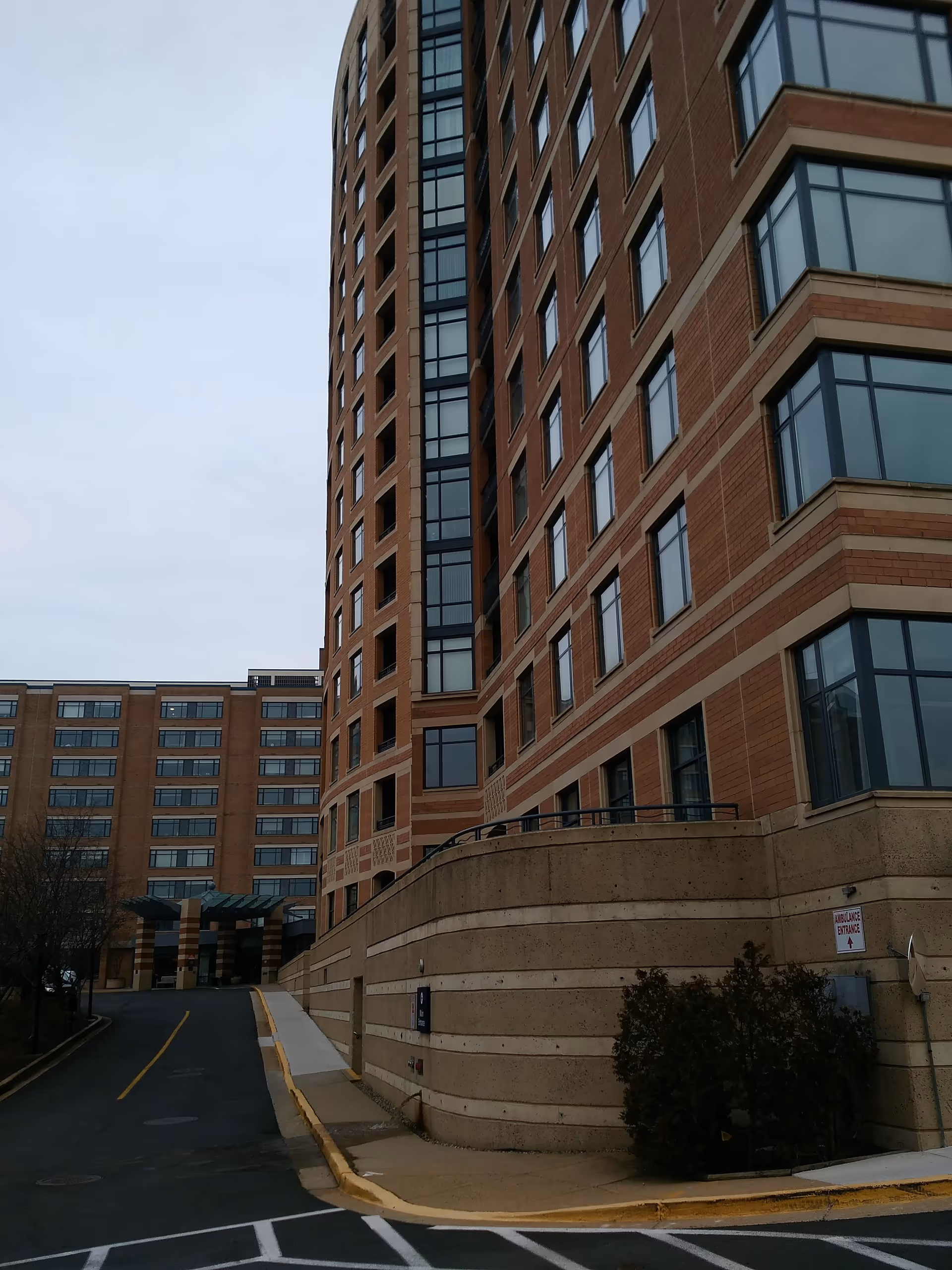 Exterior view of a tall brick senior living building.