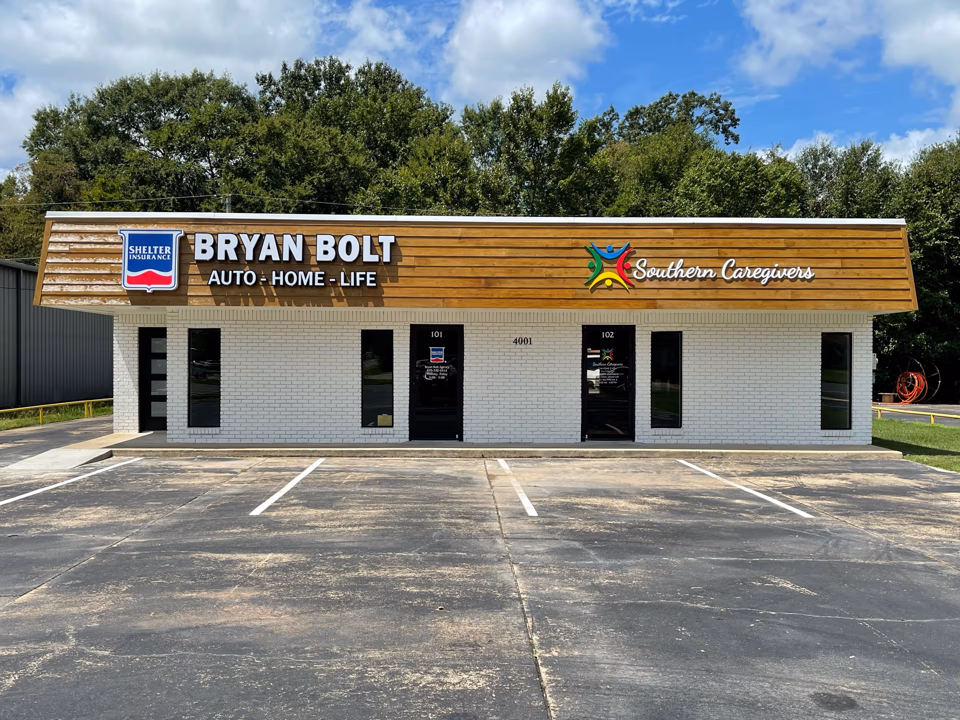 Single-story storefront with signs for Bryan Bolt Auto-Home-Life and Southern Caregivers.