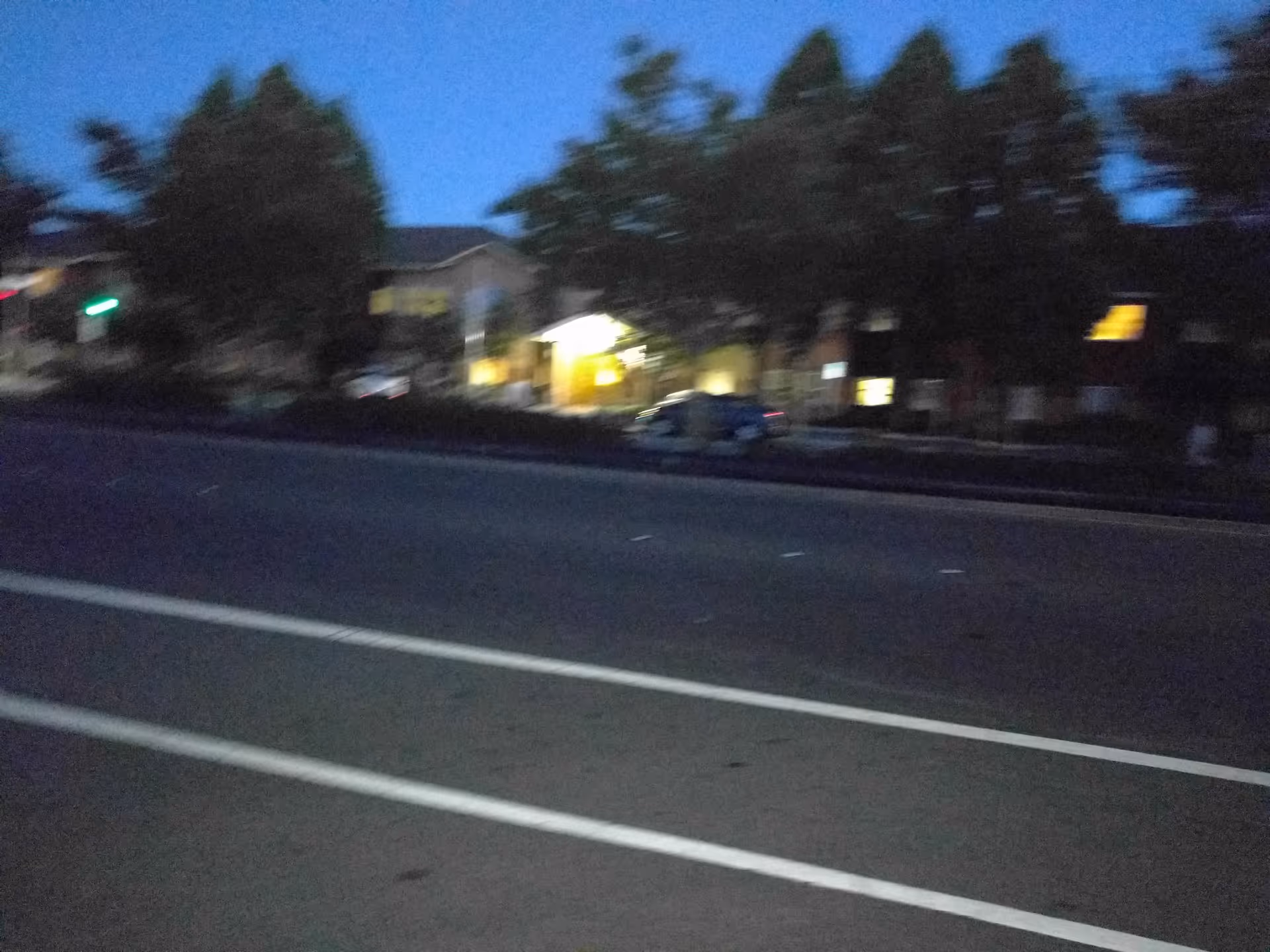 Dusk view of Alvarado Senior Living exterior with illuminated entry along the street.