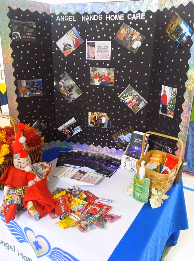 Interior display booth for Angel Hands Home Care with photos and a candy table
