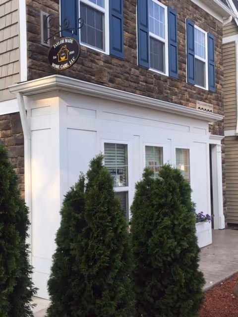 Exterior view of Taylor Made Home Care, LLC building with windows and shrubbery.
