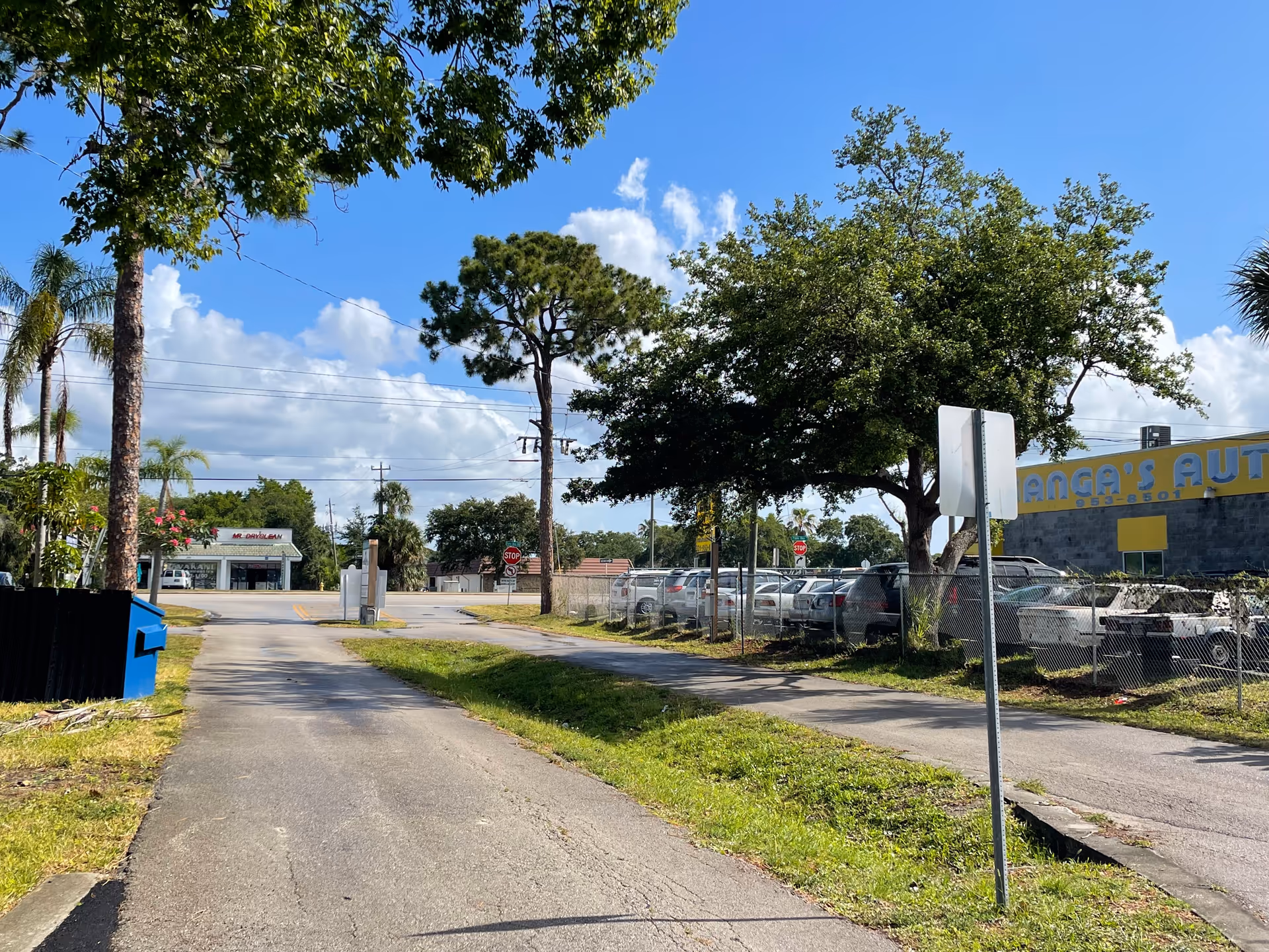 Exterior view of Angie’s Senior care and staffing facility with parked cars, fence, and large trees.