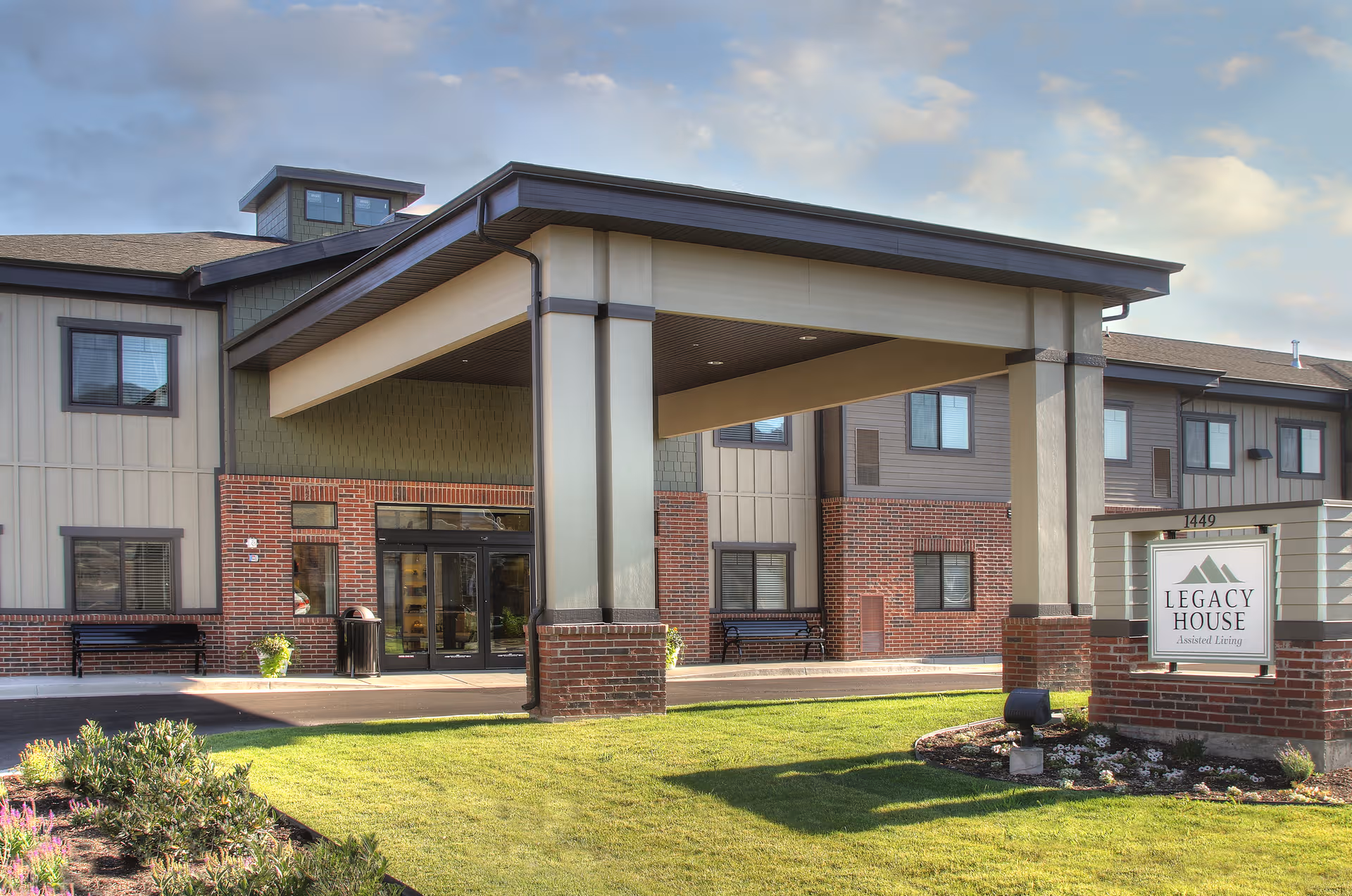 Front entrance of Legacy House Assisted Living with a covered entry and sign.