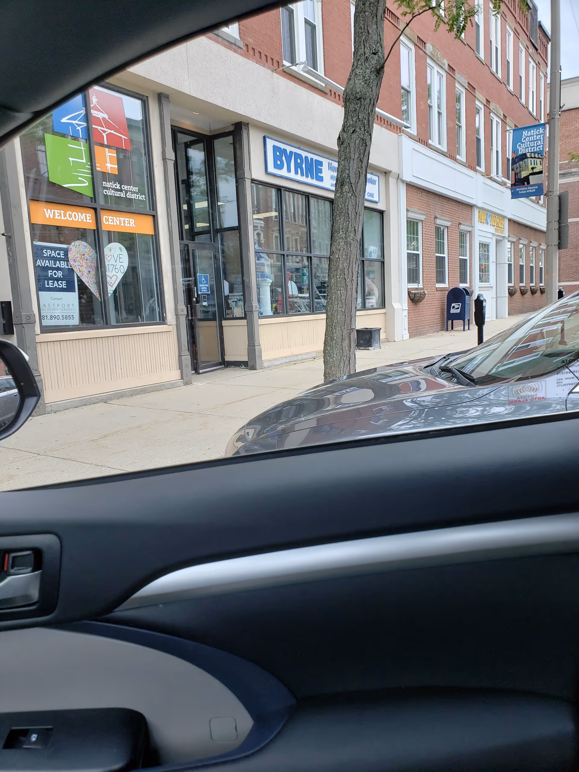 Exterior street view of Byrne Home Health Center storefronts and neighboring shops
