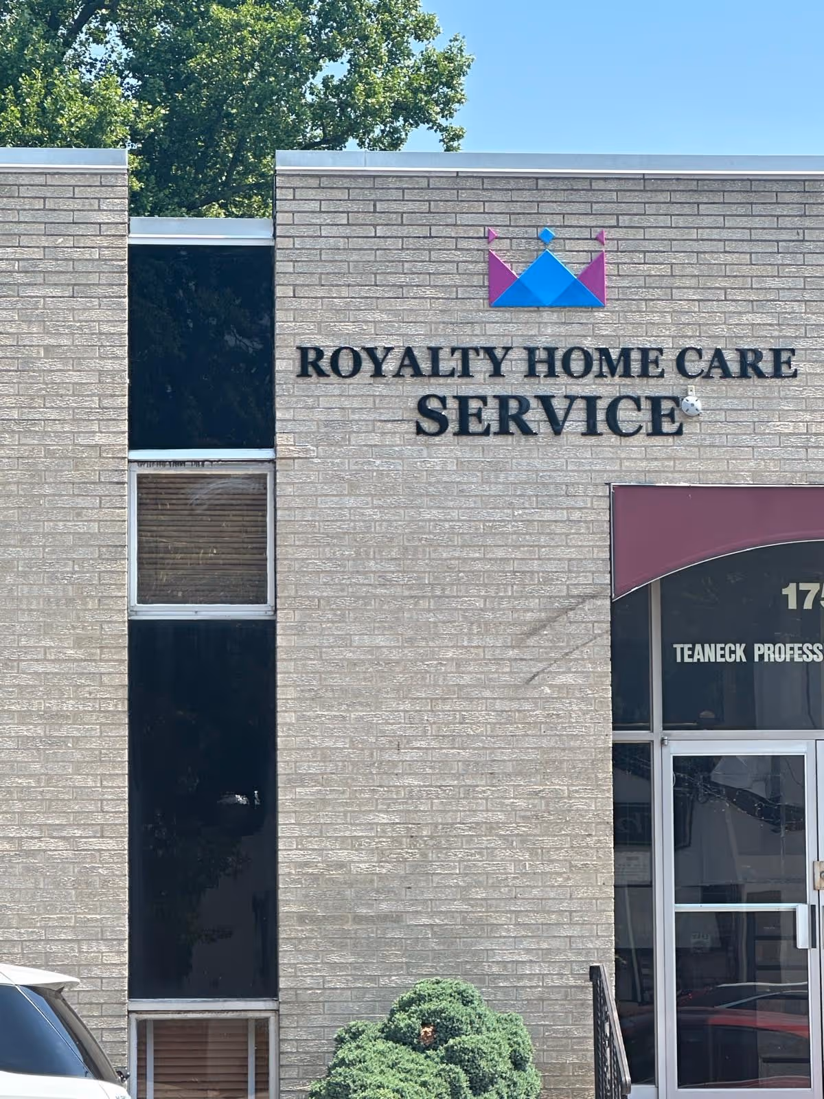 Exterior view of Royalty Home Care Service building with its sign and entrance.