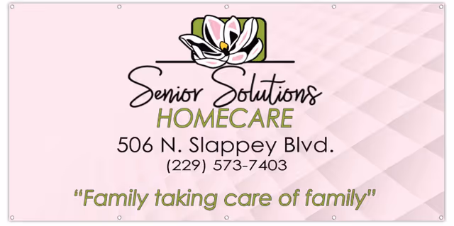 Pink banner sign for Senior Solutions Homecare showing address and slogan.