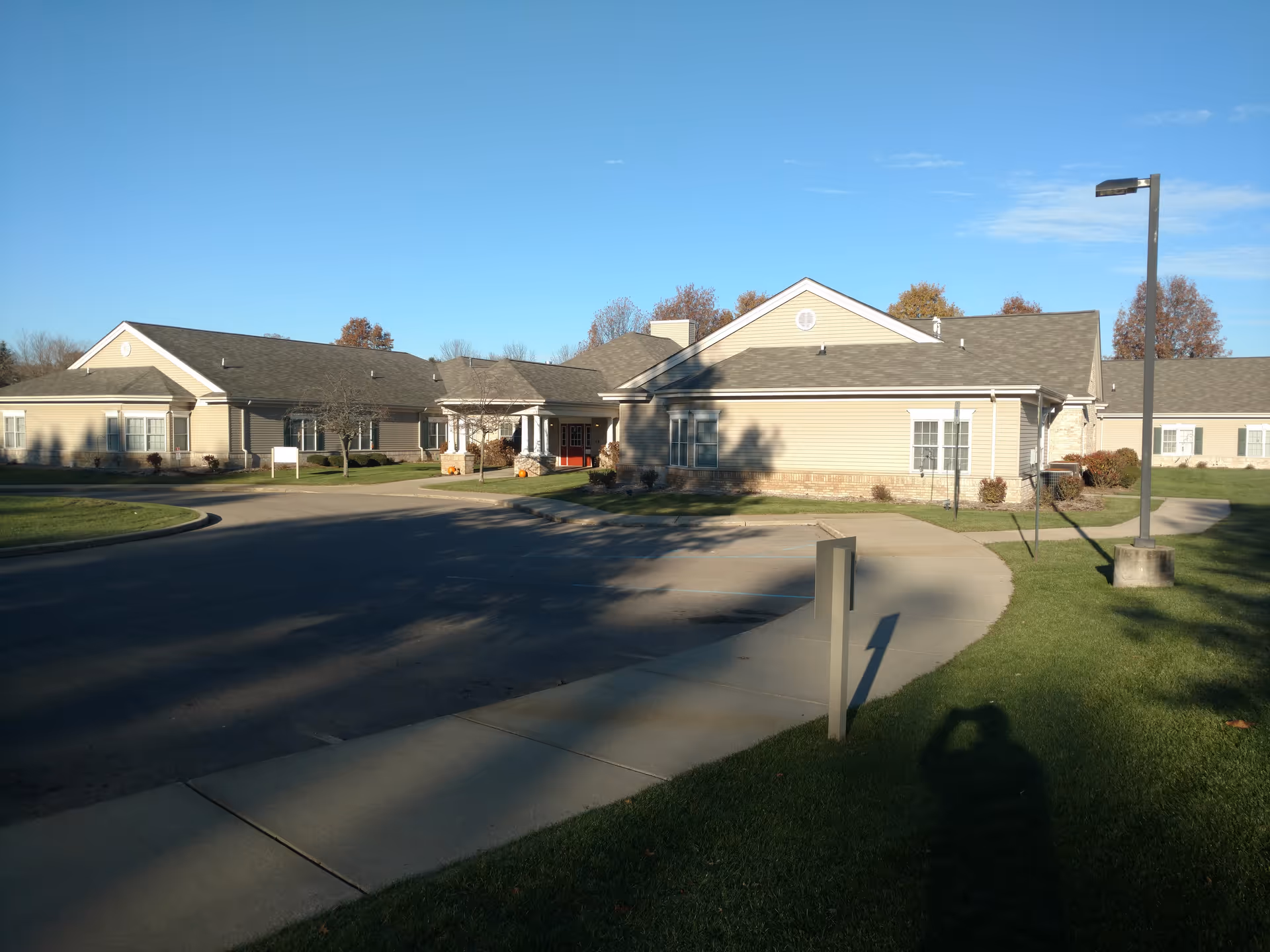 Brookdale Portage Memory Care exterior: a single-story beige building with curved driveway and lawns.