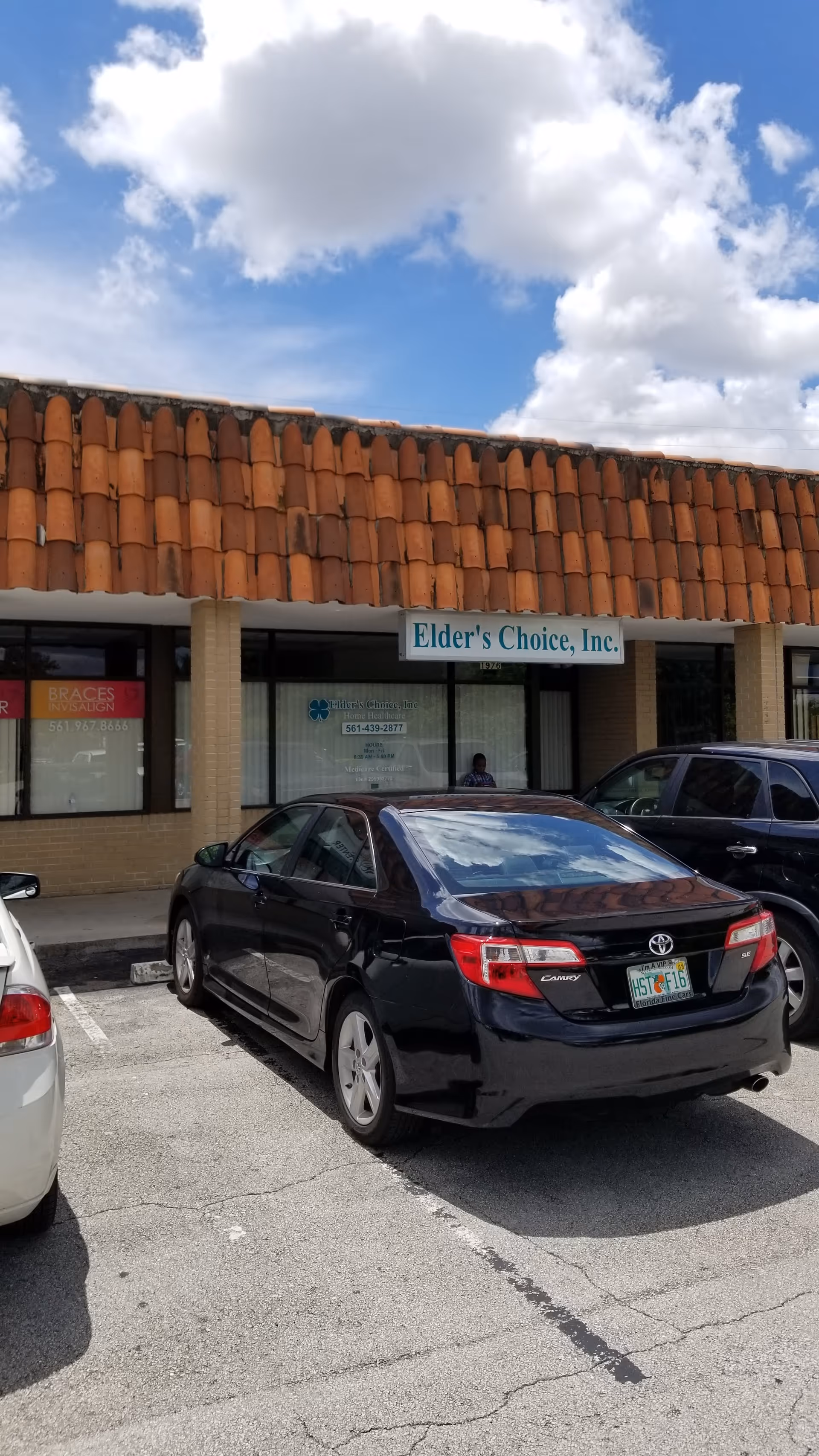 Exterior storefront of Elder's Choice, Inc., with parked cars in front.