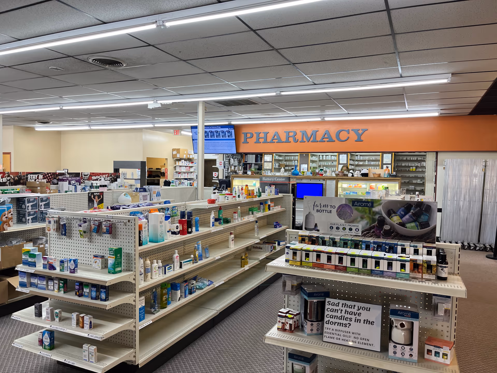 Interior view of Petersen Drug pharmacy with product shelves and a counter.