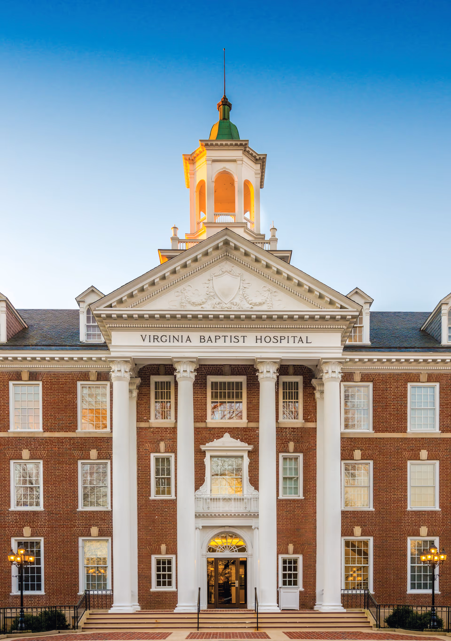 Front view of Virginia Baptist Hospital building with brick facade and tall central columns.