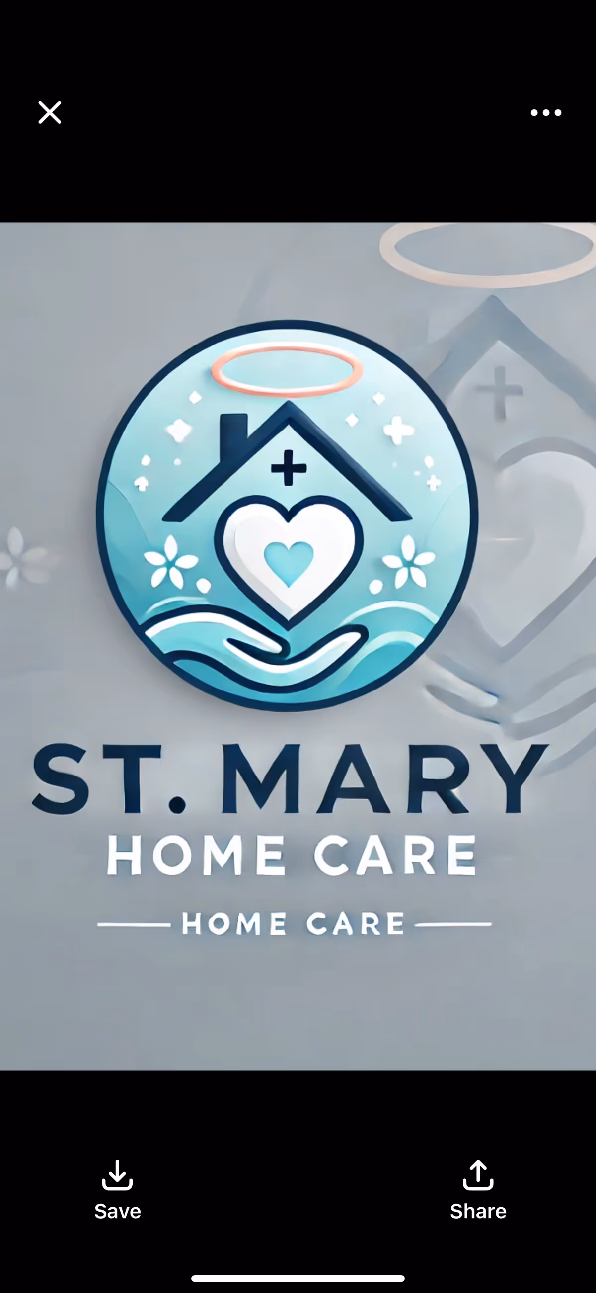 A circular St. Mary Home Care sign with a house, heart, and halo on a wall.