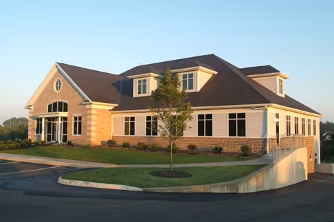 Front view of Evergreen Pain Management and Rehabilitation Center, a single-story building with brick and siding.