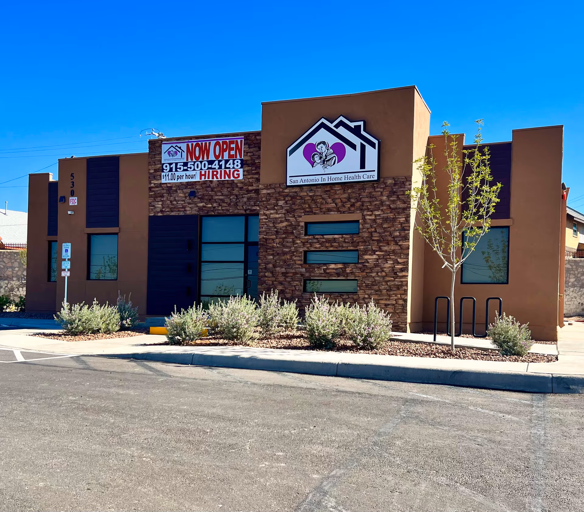 Front view of San Antonio In Home Health Care building with banner and stone facade.