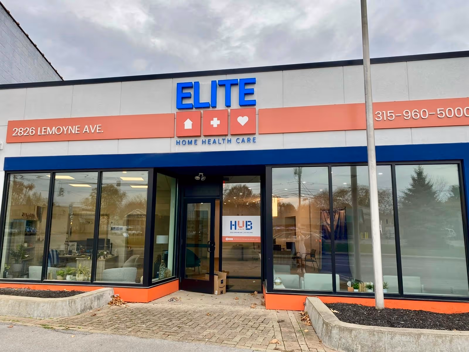 Exterior view of Elite Home Health Care storefront with large glass windows and entrance.
