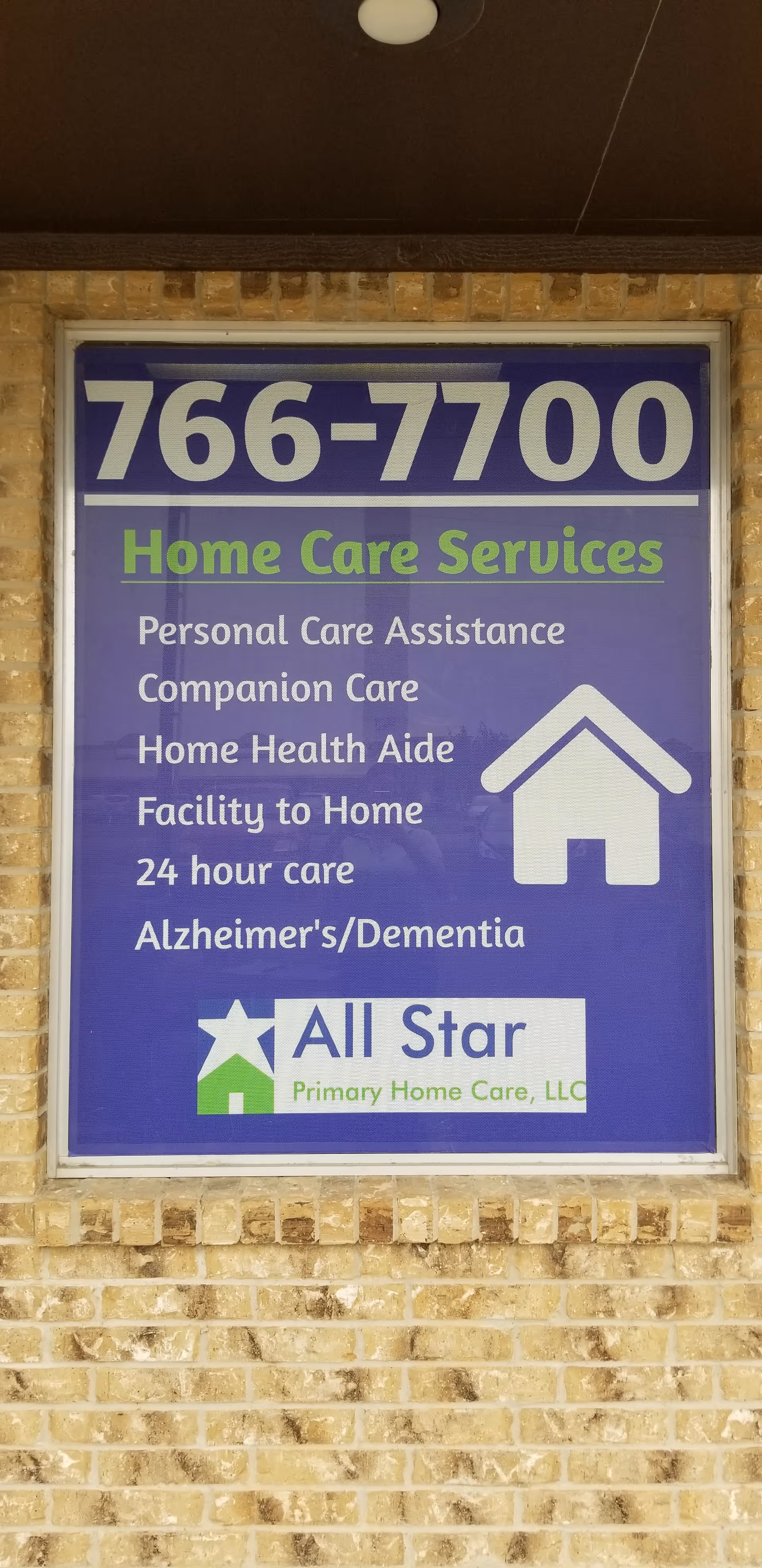Sign advertising All Star Primary Home Care on brick exterior wall.
