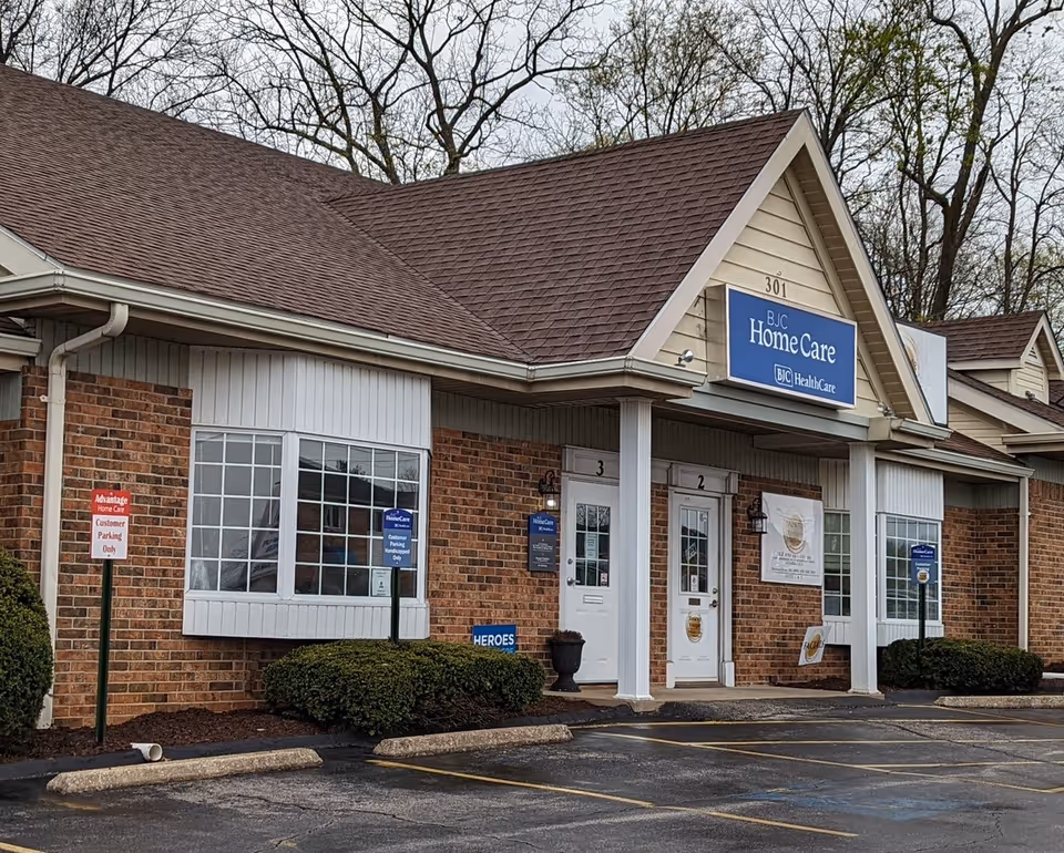 Single-story brick building with a blue BJC HomeCare sign and two doors.